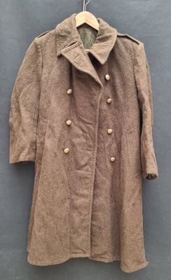 an old coat hanging on a hanger on a wall