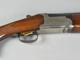 a close up of a rifle on a table with a white background