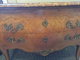 a dresser with a marble top in a room