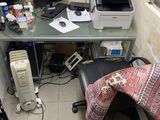 a desk with two computers and a printer on it