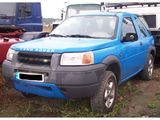 a blue truck that is parked in the grass