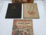 three books sitting on top of a white table next to each other