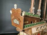 a wooden model of a ship on display on a table