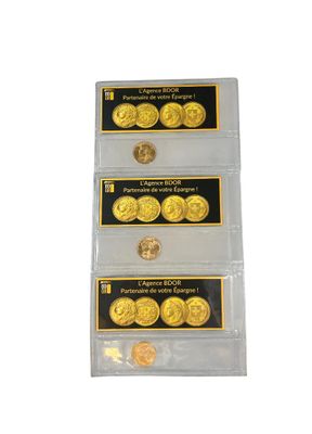 a set of three gold coins in a clear plastic holder