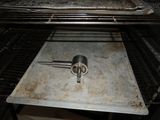 a metal tray with a spatula on it in an oven
