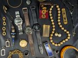 many different types of watches and bracelets laid out on a table