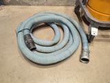 a hose that is sitting on the ground next to a machine