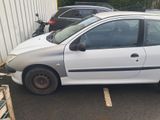 a white car parked in a parking lot next to other cars
