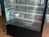 a glass display case in the middle of the floor