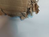 a cardboard box with a hole in it on a table