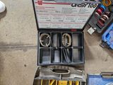 a box of tools sitting on the ground next to other tools