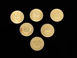 six gold coins are arranged in a triangle on a black background