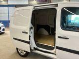 a white van with its doors open in a garage