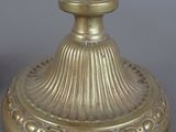 pair of antique brass candlesticks on a grey background