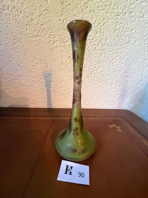 a green vase sitting on a table with a price tag on it