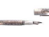 two pens sitting next to each other on a white surface