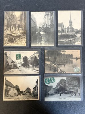 several old black and white photos of a street and buildings