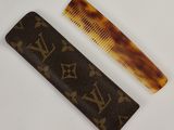 pair of brown combs sitting next to each other on a white surface