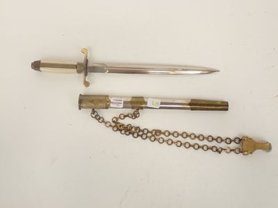two knives and a chain are laying on a white surface