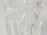 a clear glass vase with gold accents on it