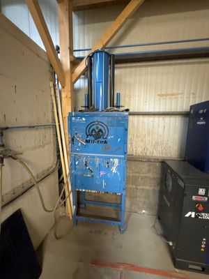 a blue machine that is sitting in a garage