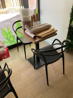 a table and chairs in a room with a window