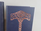 pair of blue book covers with a gold celtic design on them