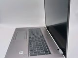 a silver laptop with a black keyboard on a white surface
