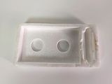 a plastic box with a hole in it on a white surface