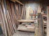 many pieces of wood stacked up in a room