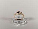 a close up of a gold ring with a black stone on it