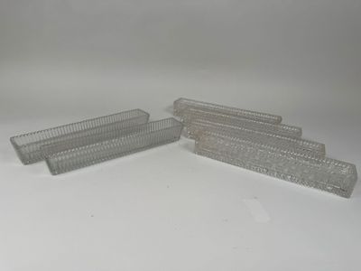 three clear plastic containers are lined up on a white surface