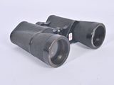 pair of binoculars on a white surface with a white background