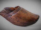an old wooden shoe brush holder on a gray background