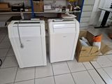 two refrigerators that are sitting in a room