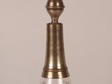 a glass bottle with a gold top on a table