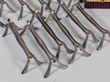 a lot of forks and spoons on a table