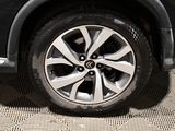 a close up view of a car ' s wheel on the ground