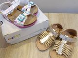 a pair of baby shoes on a table next to a shoe box