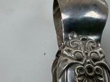 a silver spoon that has a face on it