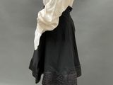 an image of a mannequin wearing a white shirt and black skirt