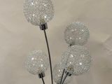 a vase with three glass balls on top of it