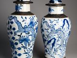 pair of blue and white vases with birds and flowers on them