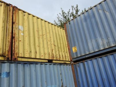 many containers stacked on top of each other on the ground