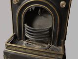 a black and gold fire place with plates on top of it