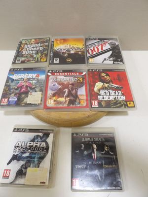 many video games sitting on a table with a bowl of them