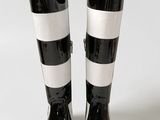 pair of black and white rain boots on a white surface