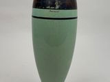 a green vase with a black stripe on it