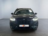 the front view of a black car in a white room