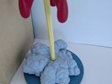 a toy rocket ship sitting on top of a blue plate